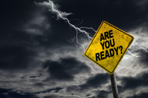 Are You Ready sign against a stormy background with lightning and copy space. Dirty and angled sign adds to the drama.